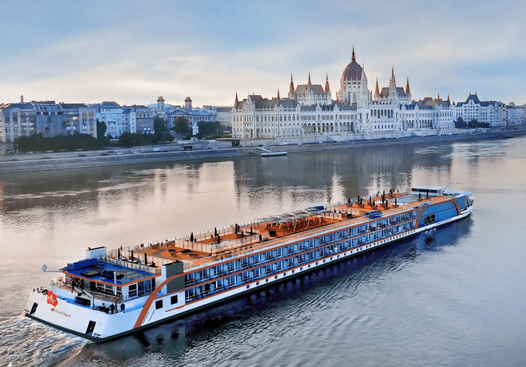 AmaWaterways river cruise in Europe with stunning architecture in the background.