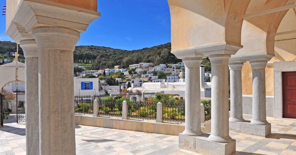 Historic stone pillars overlooking the scenic green mountains and valleys surrounding the village of Lefkes in Paros, Greece.